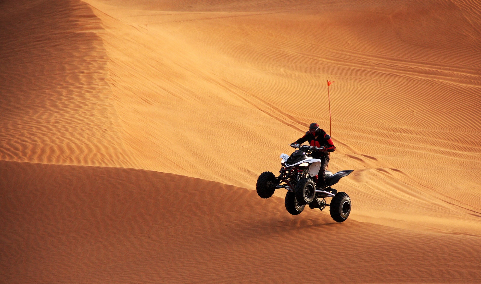 Man riding quad bike in desert Dubai.