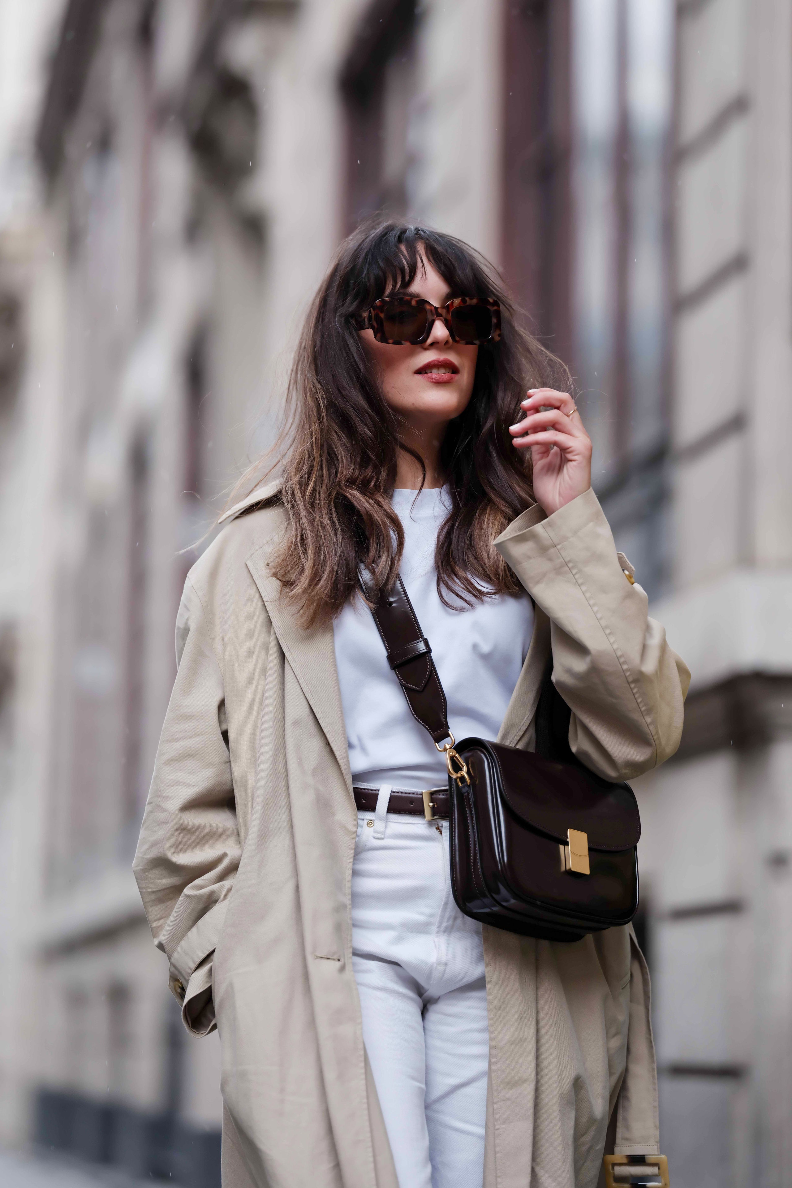 PARIS FRANCE  APRIL 03 Sarah Benziane wears a white tshirt a brown pullover over the shoulders a beige trench coat from...