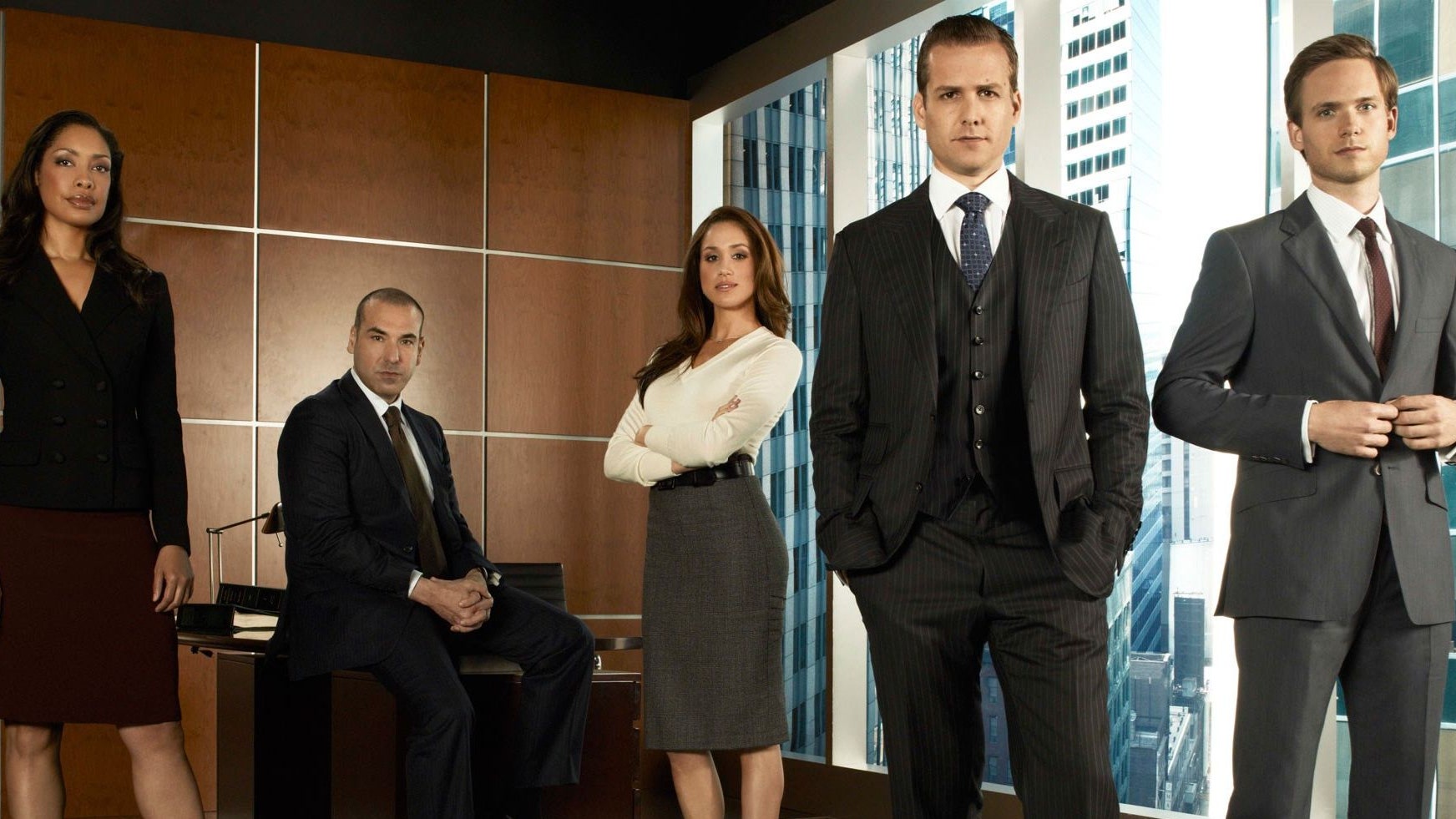 Image may contain Rick Hoffman Gina Torres Clothing Apparel Human Person Overcoat Coat Suit and Gabriel Macht