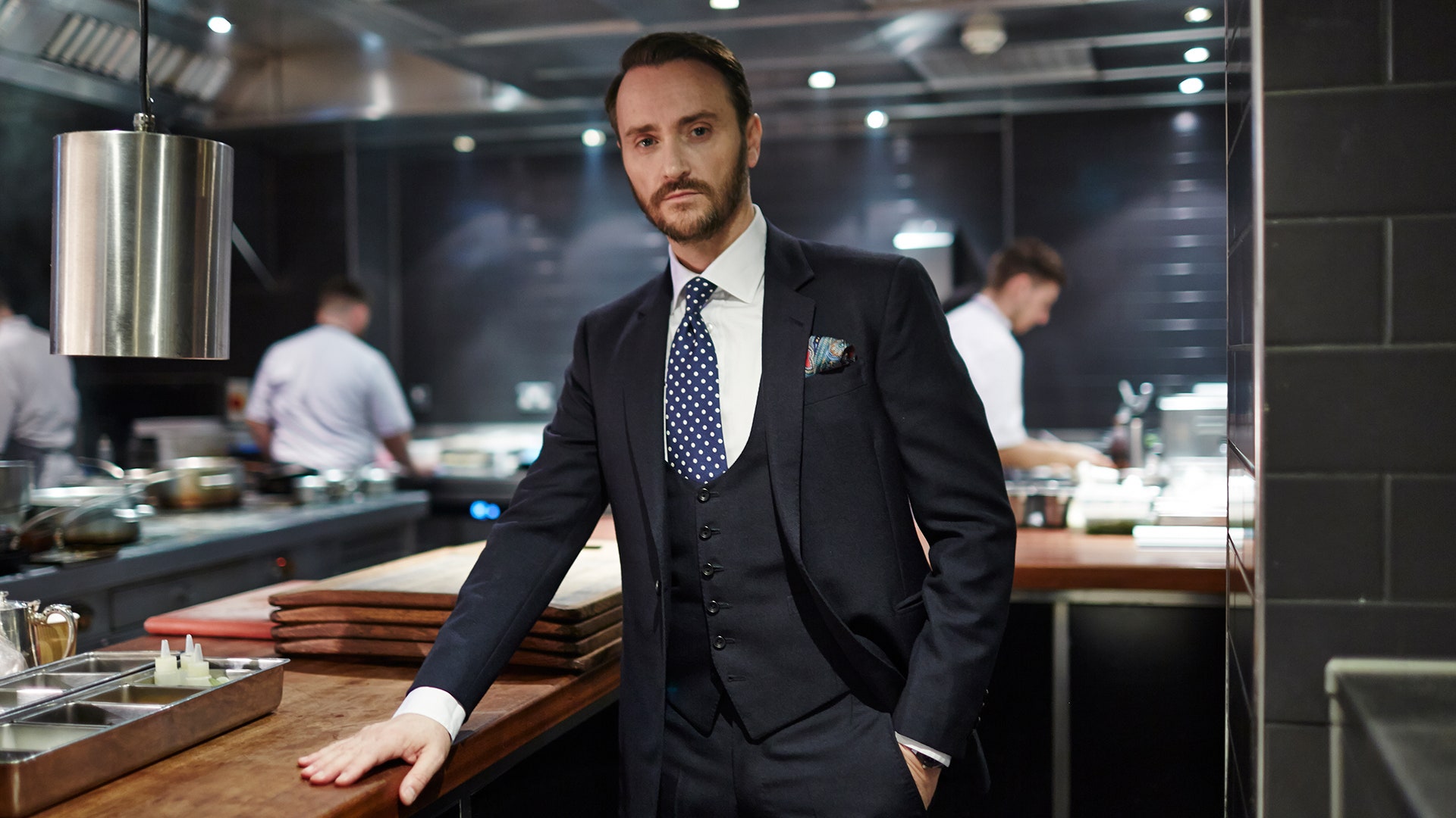 Image may contain Jason Atherton Human Person Clothing Suit Overcoat Coat Apparel Tie Accessories and Accessory