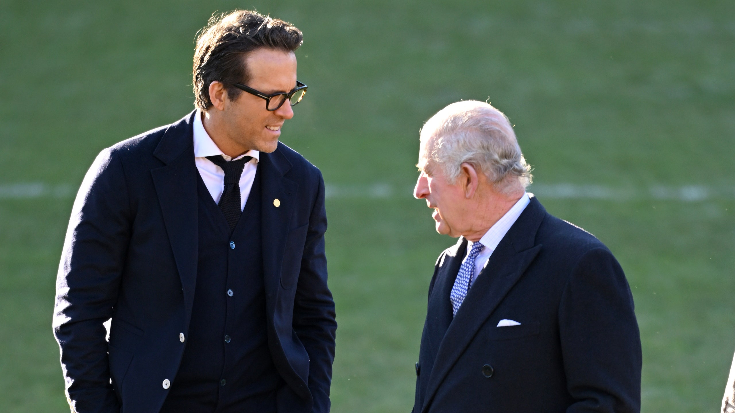 King Charles III talks with coowner of Wrexham AFC Ryan Reynolds during their visit to Wrexham AFC on December 09 2022...