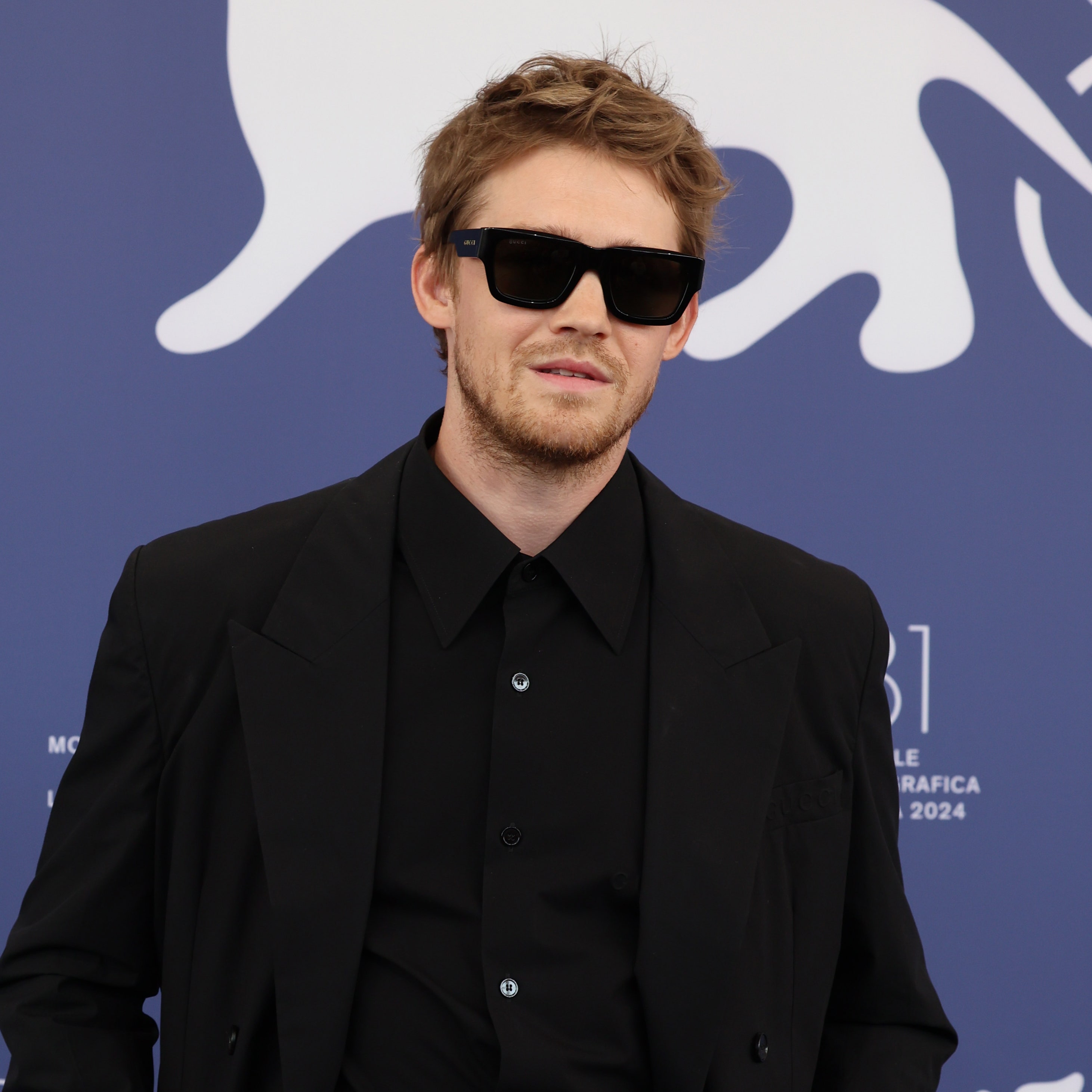 Joe Alwyn won't stop dressing like a hot Bond villain