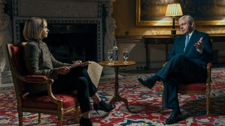 Image may contain Michael Sheen Conversation Person Lamp Clothing Footwear High Heel Shoe Interview and Chair