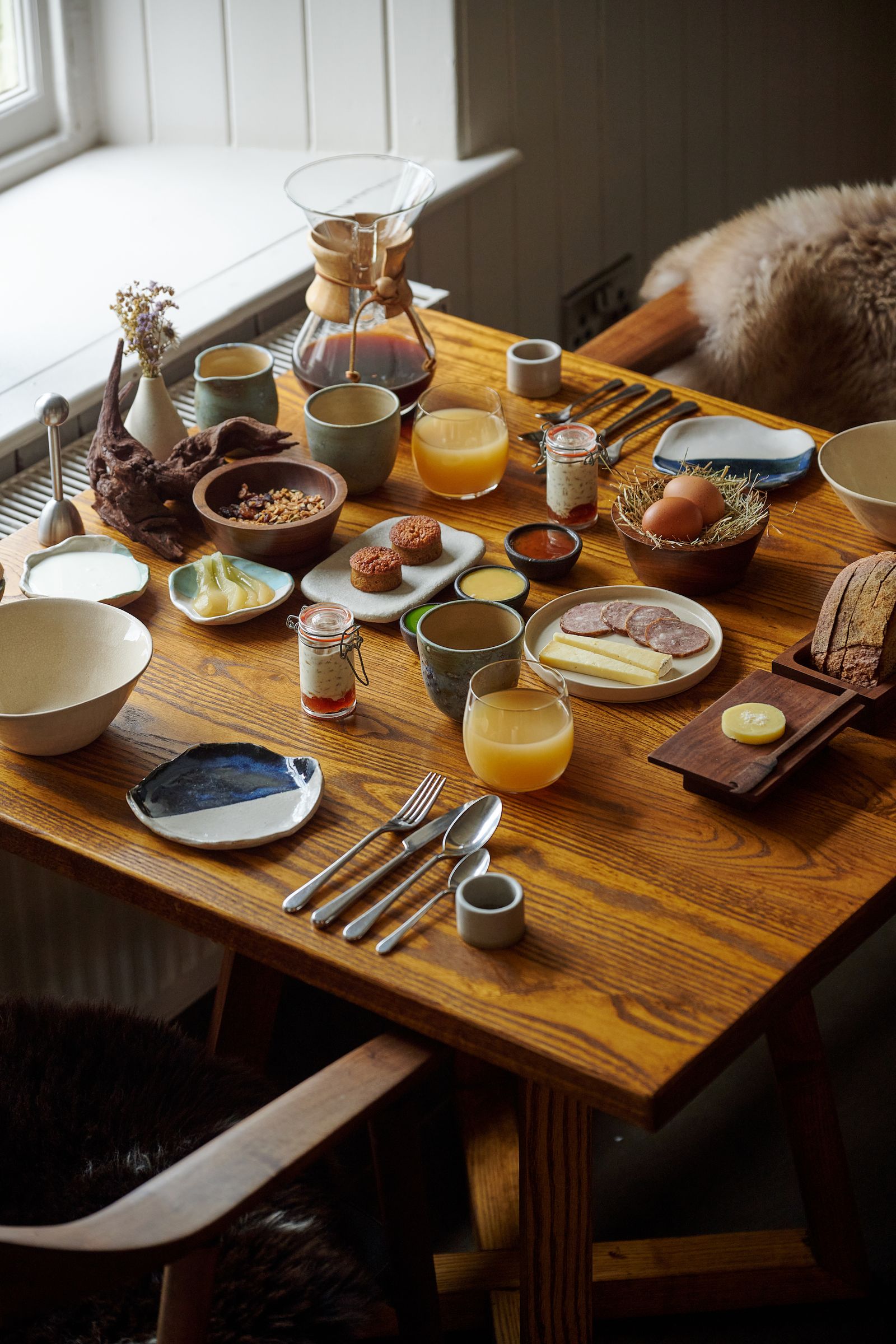 Image may contain Brunch Food Furniture Table Tabletop Dining Table Cutlery Fork Spoon Cup Egg Plate and Bread