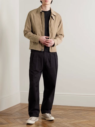 Image may contain Clothing Coat Person Standing Adult Pants Jacket and Blazer