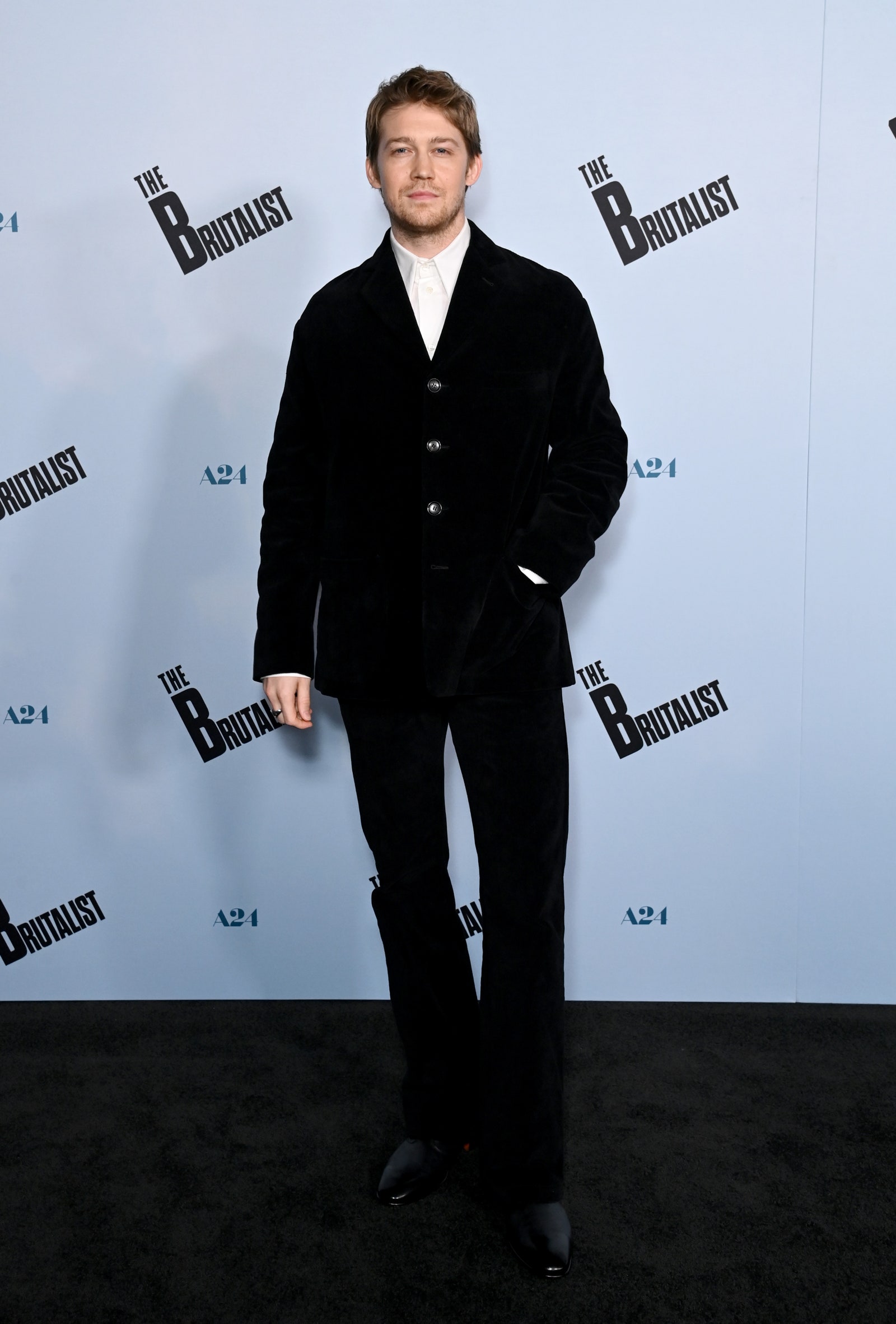 Image may contain Joe Alwyn Clothing Formal Wear Suit Person Standing Adult Coat Tuxedo Fashion Footwear and Shoe