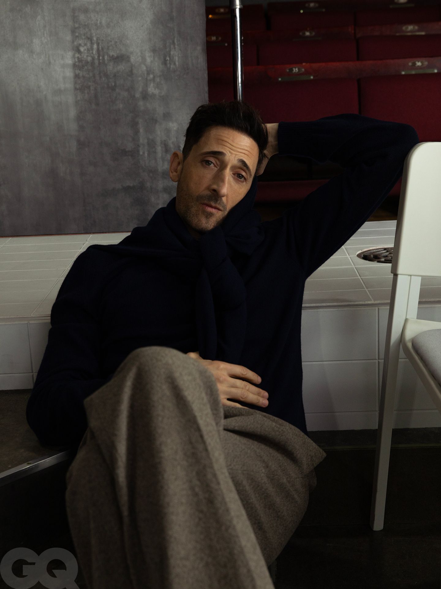 Image may contain Adrien Brody Face Head Person Photography Portrait Clothing Pants Sitting Coat Adult and Jacket