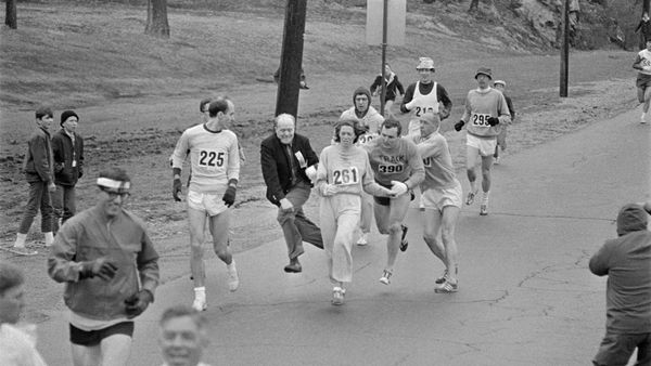 Men competing in outdoor sporting event, black and white.