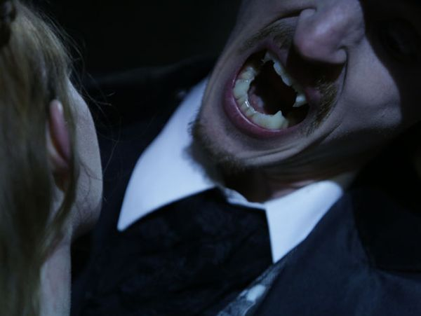 A vampire bites his victim on Monsters and Mysteries in America.