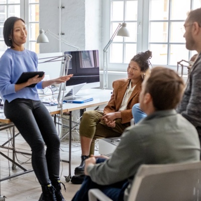 Group of office workers working in an open concept office.