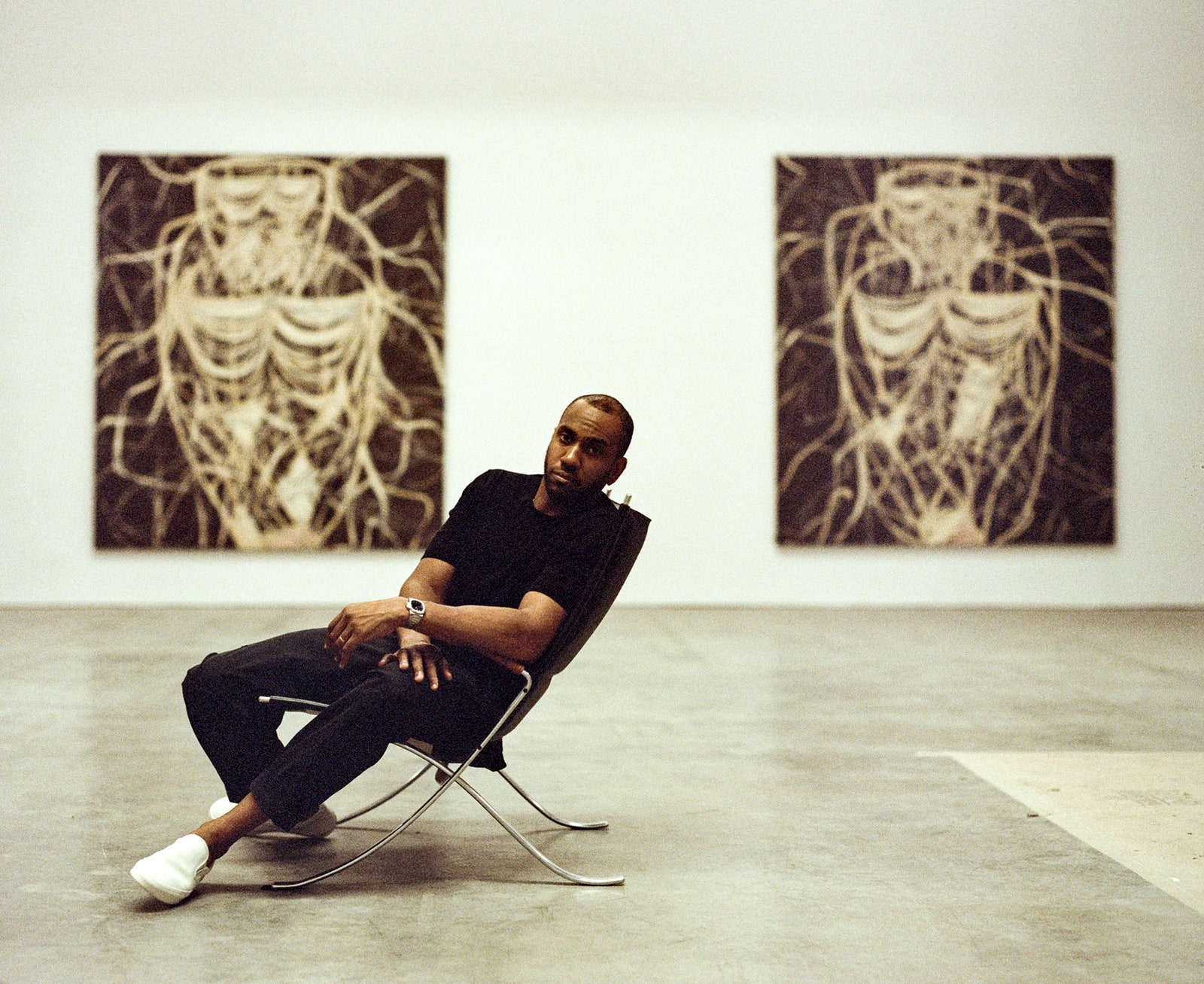 Image may contain Rashid Johnson Person Sitting Adult Clothing Footwear Shoe Wristwatch Floor Art and Chair