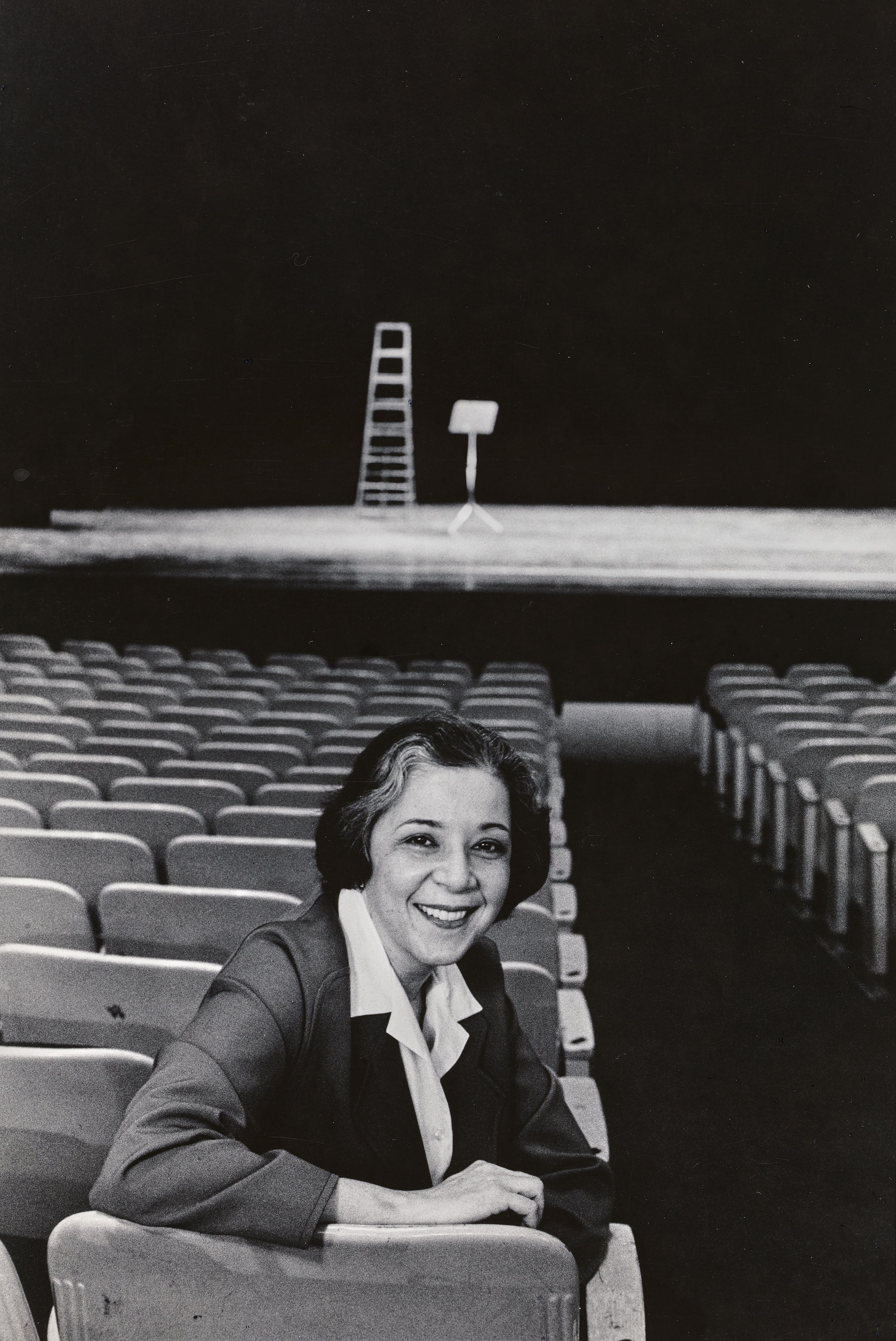 Arlene Croce sits in a chair.