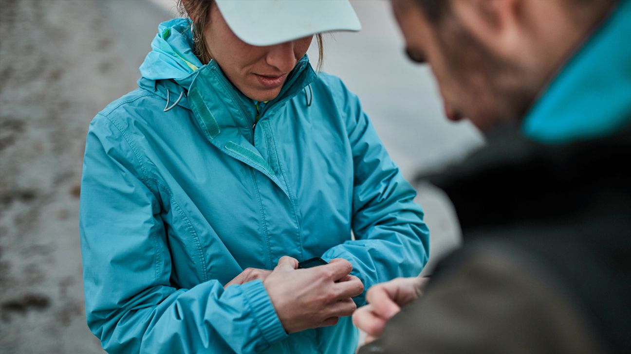 athletic woman checking fitness tracker while training