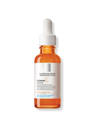 An orange and white bottle of vitamin C serum.