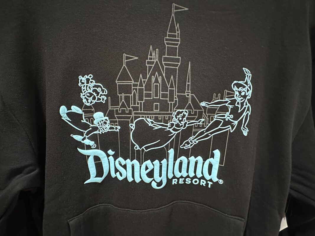 Black sweatshirt featuring a design of Disneyland Resort with Peter Pan, Wendy, John, and Michael flying in front of Cinderella's Castle; text reads "Disneyland Resort" in light blue.