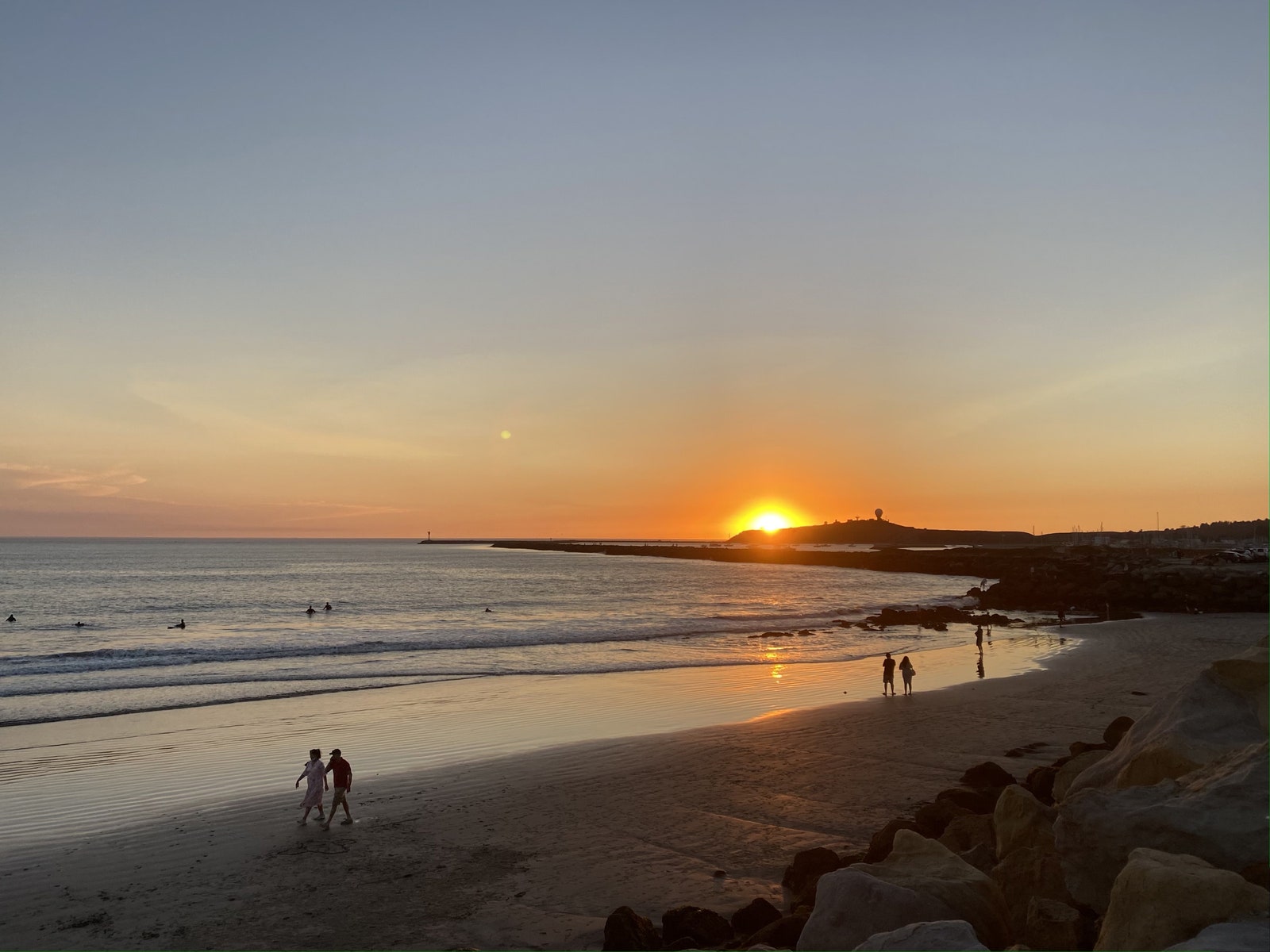 Image may contain Human Person Nature Outdoors Sunlight Light Flare Dusk Sunset Sky Dawn Red Sky and Shoreline