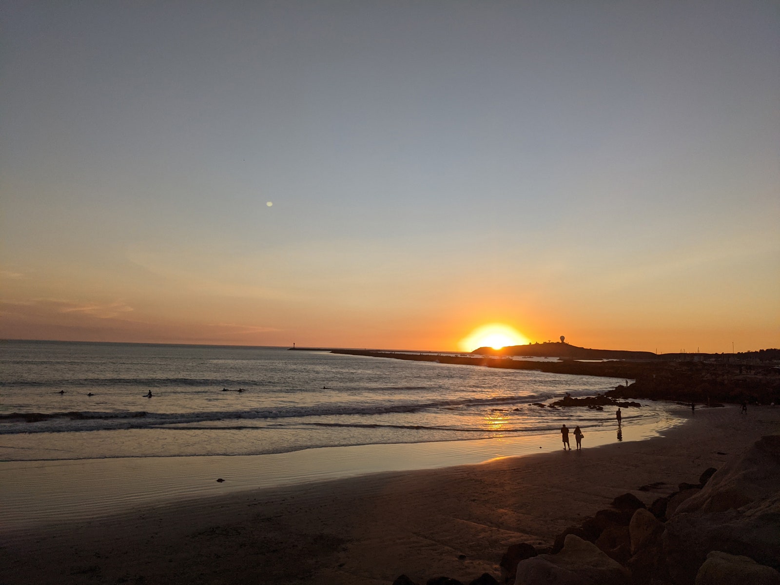 Image may contain Nature Outdoors Human Person Shoreline Water Sunlight Sunset Dusk Sky Dawn Red Sky and Ocean