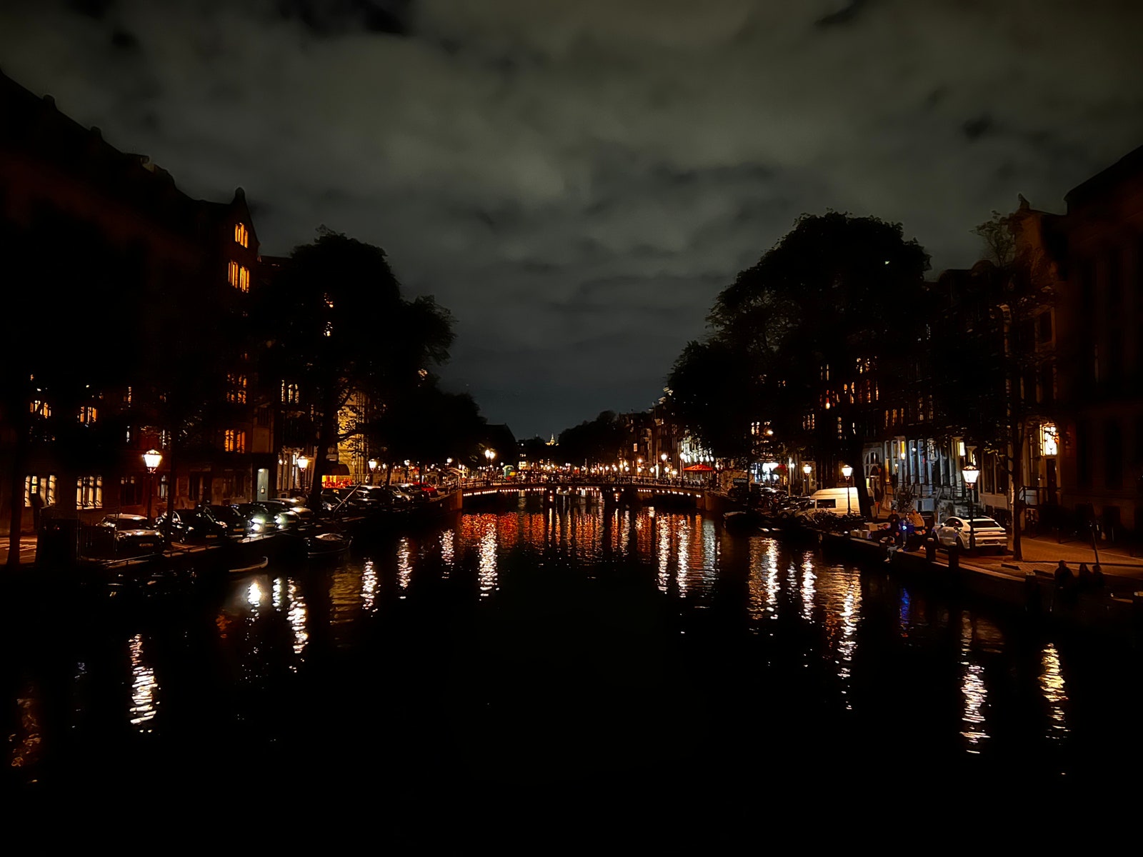 River illuminated at night by surrounding houses