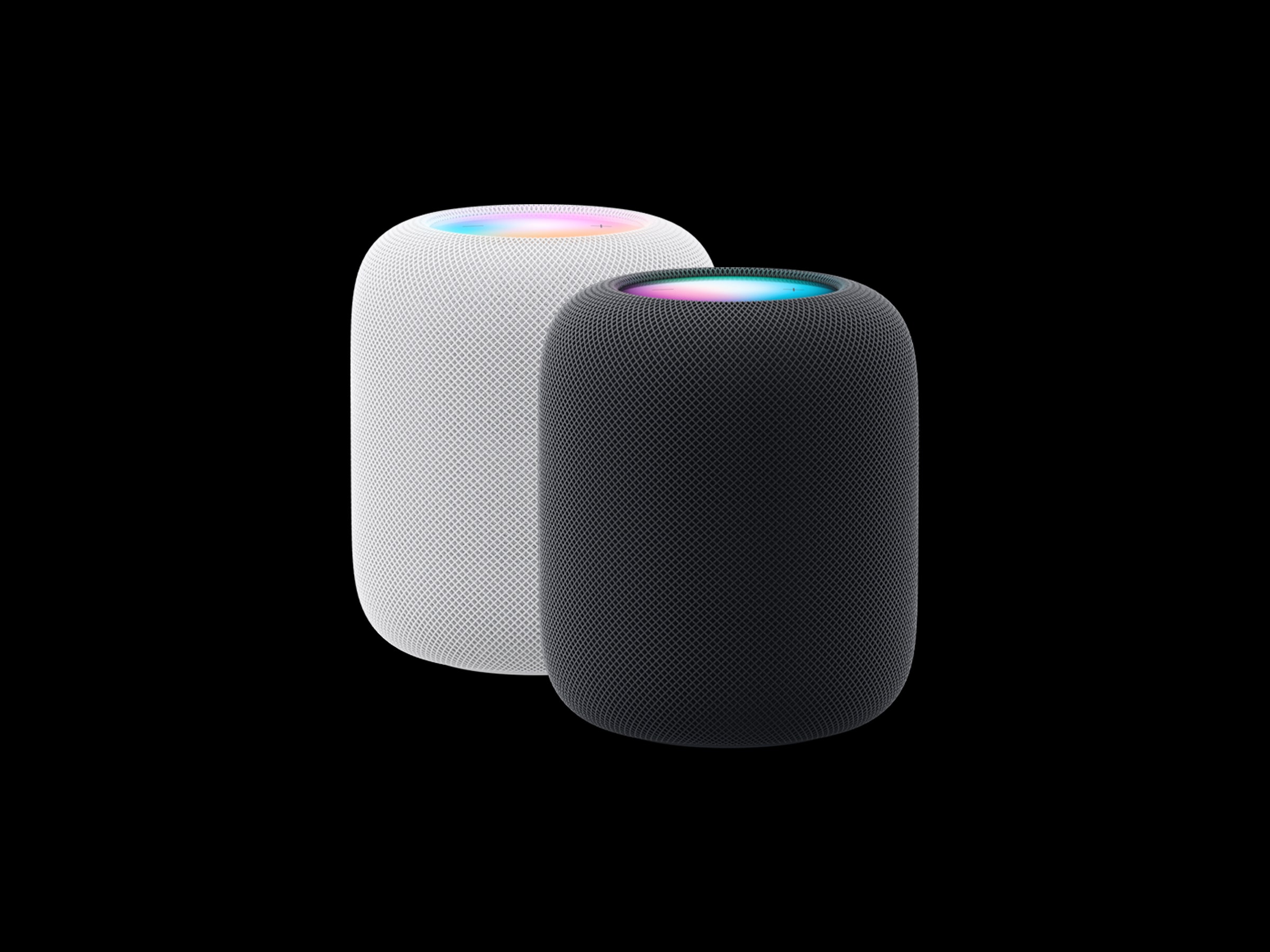 Apple HomePod in white and black on a black backdrop