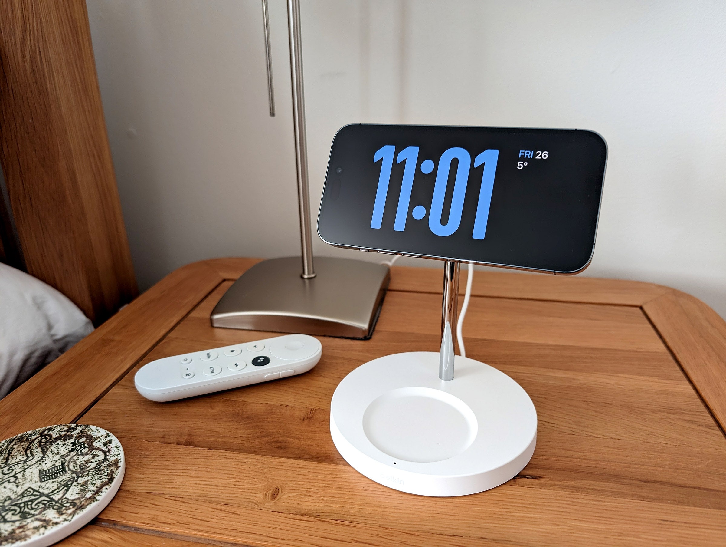 iPhone on a stand on a bedside table