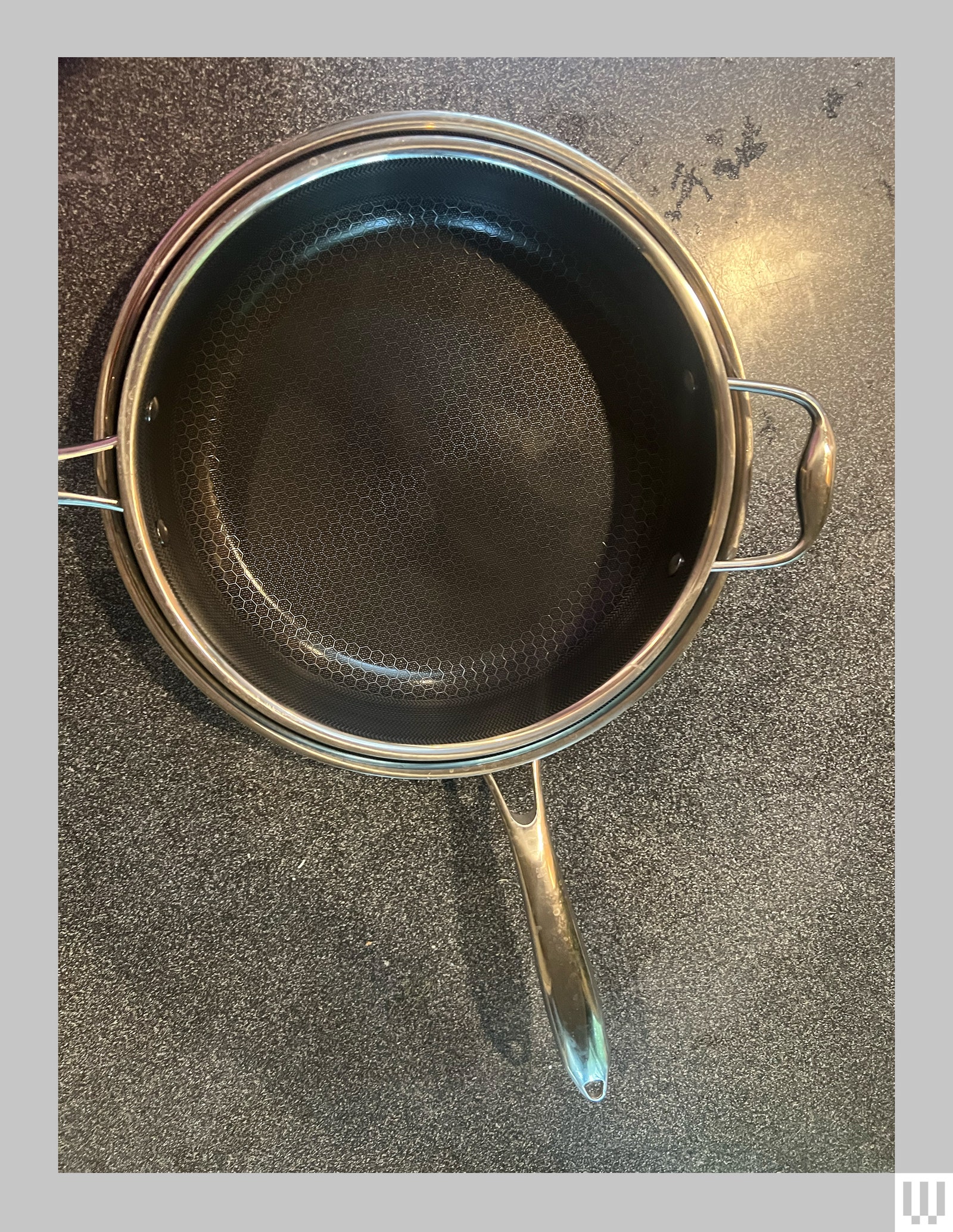 A silver pan nestled within a deep frying pan