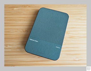 Grey rectangular device on wooden surface