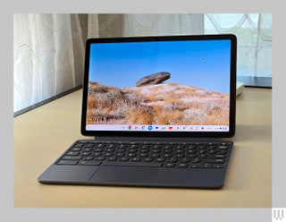 Front view of the Lenovo Chromebook Duet showing the tablet attached to the keyboard with landscape scenery on the screen