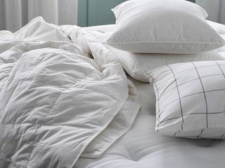 Ikea Fjallbracka Comforter a white blanket draped on a white mattress beside white pillows