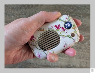 VQ Rechargeable hand warmer a floral square shaped device