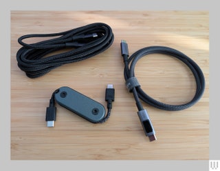 2 black cords with USBC ends and a small case for a retractable cord