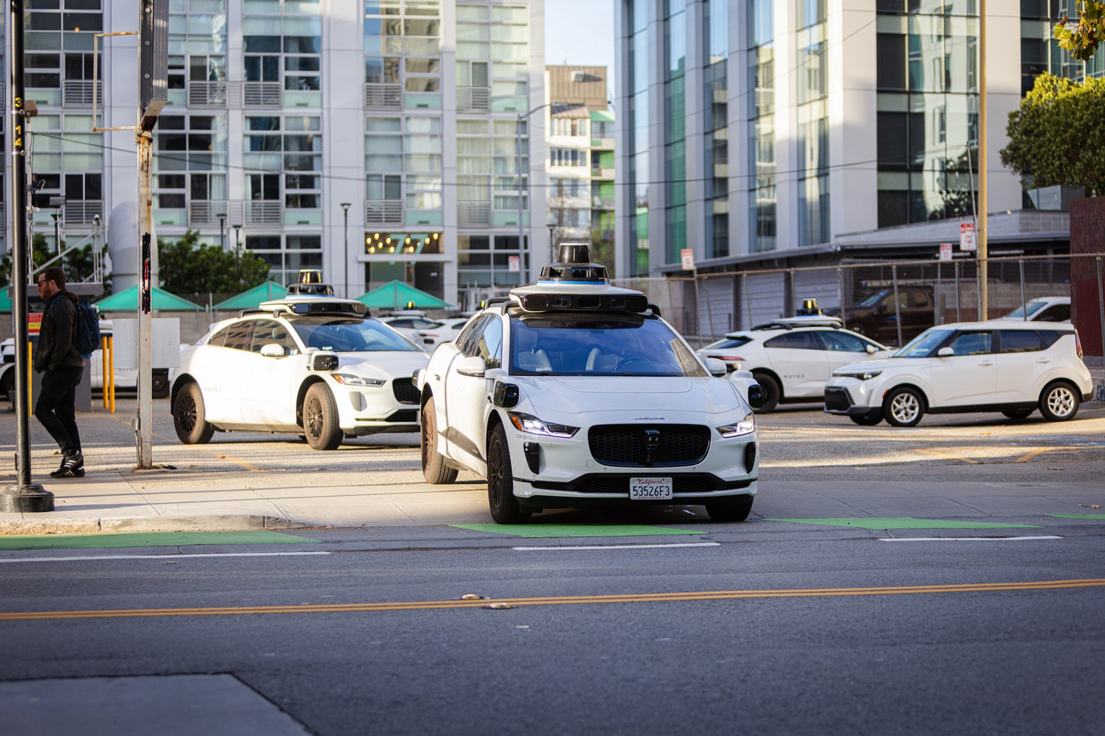 An image of a WAYMO leaving a parking lot.