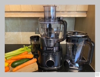 Ninja Detect Kitchen System a blender with black base and clear container beside an additional container accessory and a...