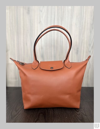 Longchamp Le Pliage Xtra M Tote bag in brown with two thin handles and foldover snapping enclosure near the top