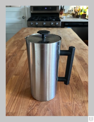 Espo P6 French Press with coffee inside sitting on a wooden countertop