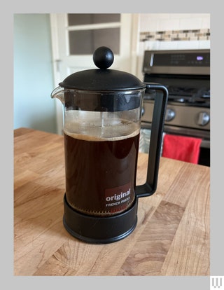 Bodum Brazil French Press with coffee inside sitting on a wooden countertop