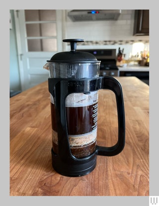 Espo P3 French Press with coffee inside sitting on a wooden countertop