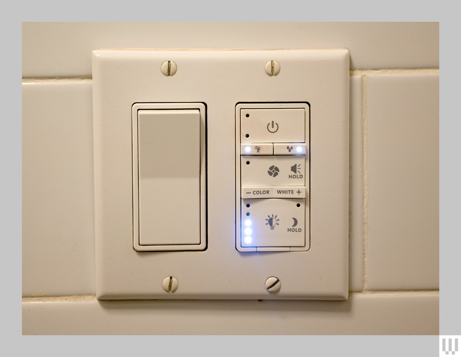 The switch for a Commercial Electric Smart Bathroom Exhaust Fan showing settings for light color power and sound