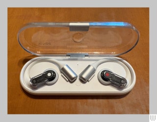 Nothing Ear Open white earbuds in an ovalshaped case with a clear lid