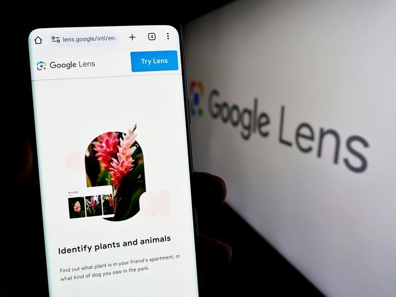 Stuttgart, Germany, 09-23-2023: Person holding smartphone with webpage of image recognition app Google Lens on screen in front of the logo.