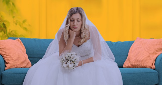 A bride sitting on a sofa looking disappointed