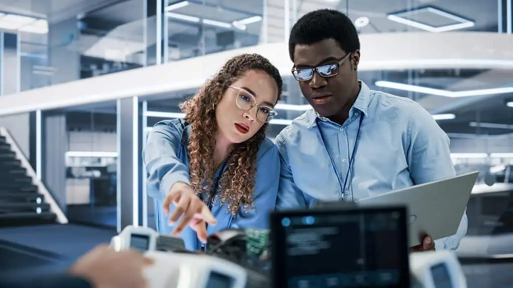 Two persons looking at a computer screen