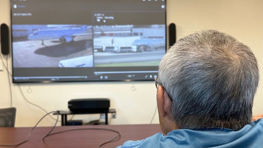 Stan Shikum watches a closed-circuit feed of a ICE Flight at Boeing Field.  The feed involves a cam...