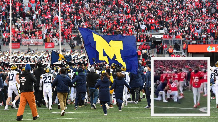 COLUMBUS, OHIO - NOVEMBER 30: Michigan Wolverines players fly a flag prior to a brawl between playe...