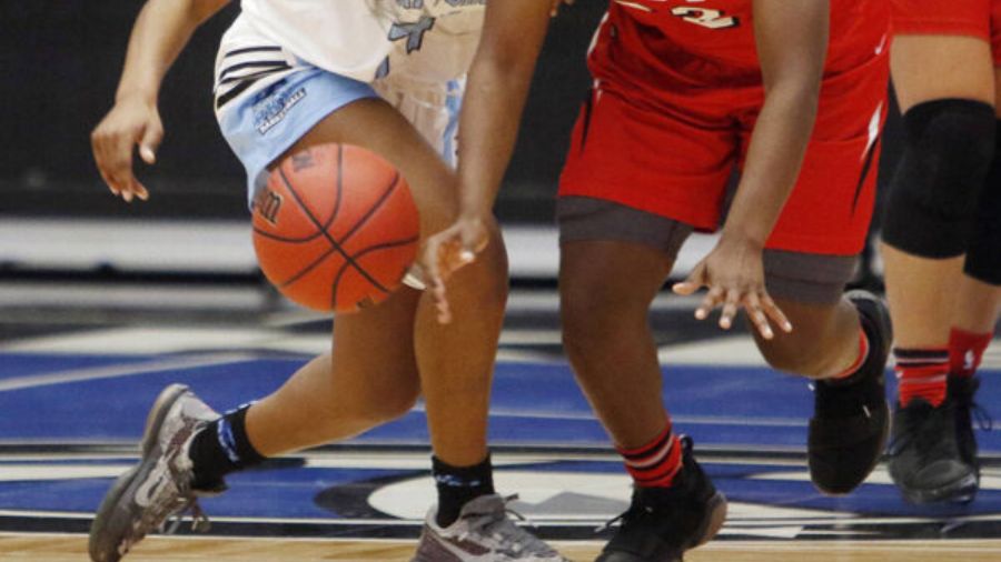 Players vie for the ball in a high school basketball game. (Photo: AP)...