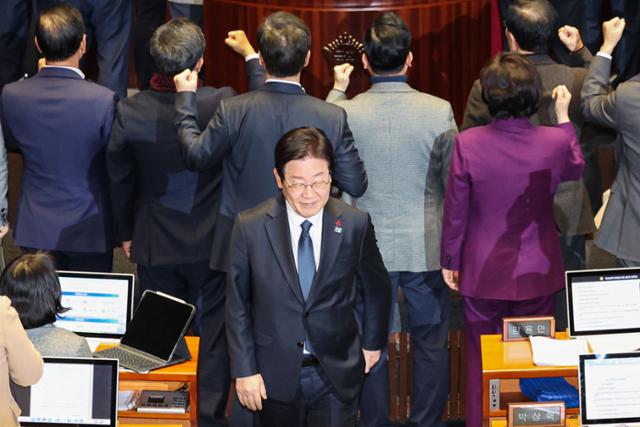 이재명 더불어민주당 대표가 27일 오후 서울 여의도 국회에서 열린 제420회 국회(임시회) 제2차 본회의에서 국무총리(한덕수) 탄핵소추안 투표를 마친 뒤 항의하는 국민의힘 의원들 뒤로 미소 지으며 이동하고 있다. 뉴시스