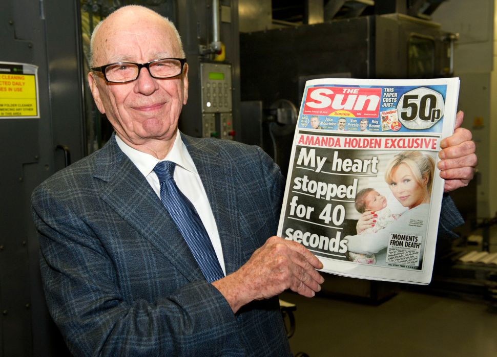 Rupert Murdoch, Chairman and CEO of News Corporation, reviews the first edition of The Sun On Sunday as it comes off the presses on February 25, 2012 in Broxbourne, England.