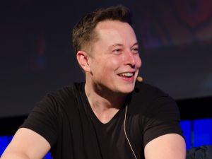 Elon Musk smiling at all the puns in his Twitter mentions.