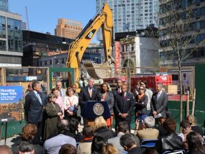 Flanked by elected officials and advocates, Mayor Bill de Blasio unveils his affordable housing plan at a press conference in May 2014.