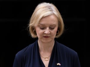 Close-up of UK prime minister Liz Truss, who is bowing her head while delivering her resignation from office.