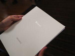 Close-up of a white folder that reads "resume" in silver letters.